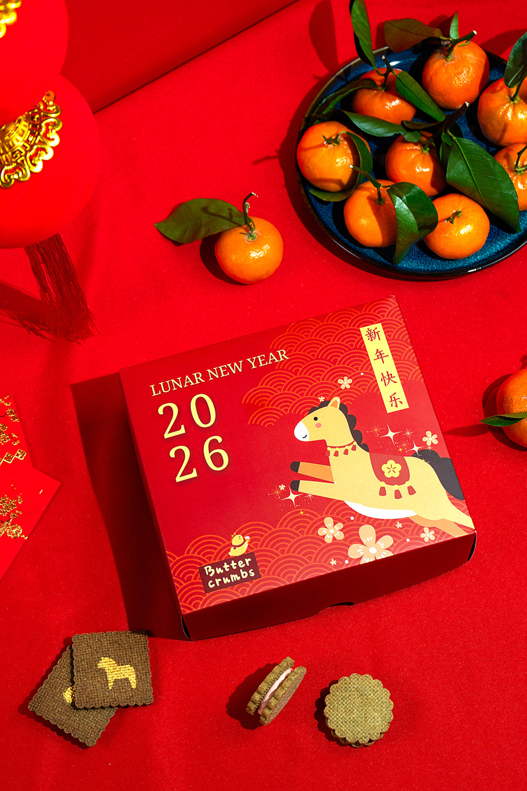 Lunar New Year 2026 themed box with a horse design on a red background with tangerines.