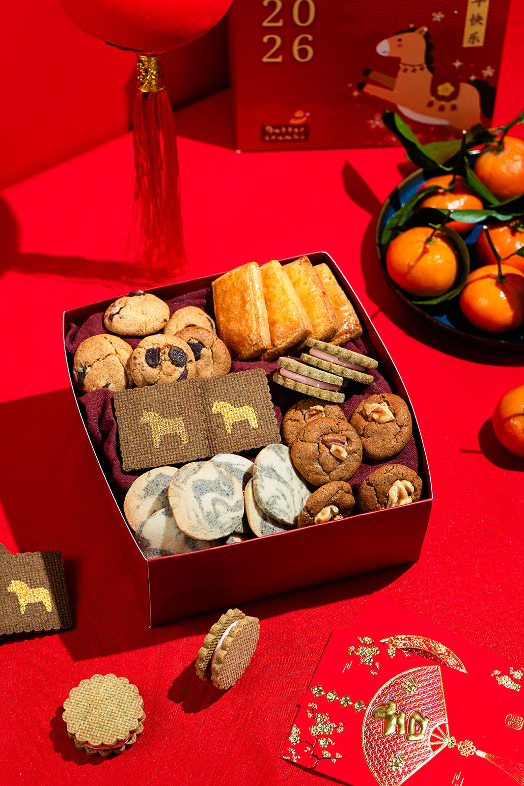 Assorted cookies in a box on a red background with festive decorations
